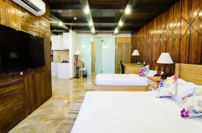 a hotel room with two beds and a flat screen tv at Mornington Hotel Sitiawan in Sitiawan