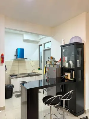 a kitchen with two stools and a counter in a room at Shahiqa Homestay Cameron Highland in Brinchang