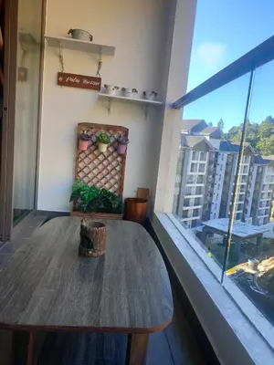 a table in a room with a large window at Shahiqa Homestay Cameron Highland in Brinchang