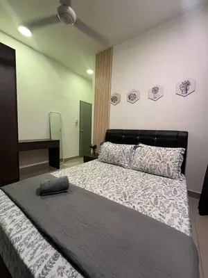 a bedroom with a large bed with a pillow on it at Shahiqa Homestay Cameron Highland in Brinchang