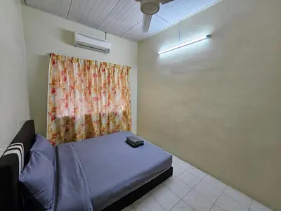 a small room with a bed and a curtain at May Flower Hostel in Ipoh