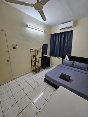 a bedroom with a bed and a ceiling fan at May Flower Hostel in Ipoh