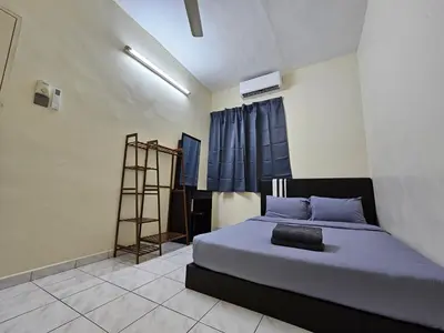 a bedroom with a bed with blue sheets and a ladder at May Flower Hostel in Ipoh