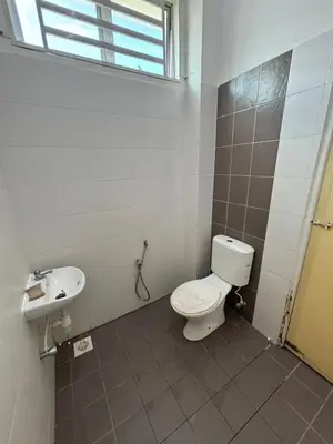 a bathroom with a toilet and a sink at MDRS Seroja 6 in Kuala Ketil