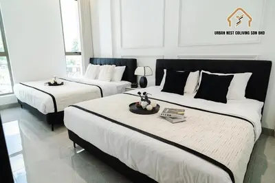 a bedroom with two beds with white and black at Georgetown Elegant Chanel-style KTV 4BR 18Pax A in George Town