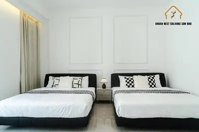 two beds sitting next to each other in a bedroom at Georgetown Elegant Chanel-style KTV 4BR 18Pax A in George Town