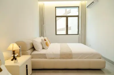 a white bedroom with a bed and a couch at Georgetown Bright & Kid-Friendly KTV 3BR 15pax C in George Town
