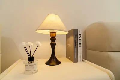 a lamp on a table next to a chair and books at Georgetown Bright & Kid-Friendly KTV 3BR 15pax C in George Town