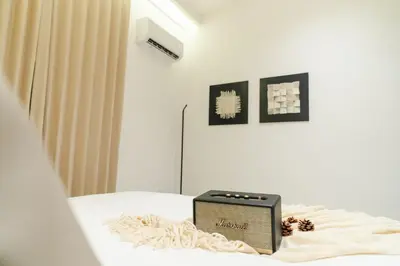 a room with a bed with a radio on it at Georgetown Stylish Design Jacuzzi KTV 5BR 16pax D in George Town