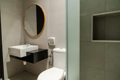 a bathroom with a toilet and a sink and a mirror at Georgetown Elegant Golden Jacuzzi KTV 5BR 16pax E in George Town