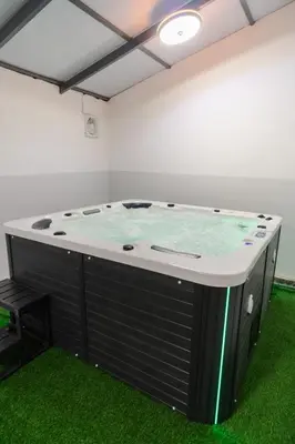 a hot tub in a room with green grass at Georgetown Elegant Golden Jacuzzi KTV 5BR 16pax E in George Town