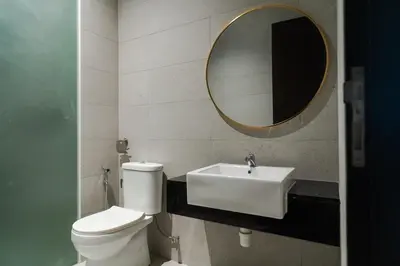 a bathroom with a toilet and a sink and a mirror at Georgetown Elegant Golden Jacuzzi KTV 5BR 16pax E in George Town