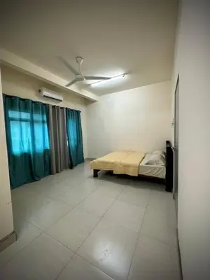 a bedroom with a bed and a ceiling fan at Homestay Adyana in Raub