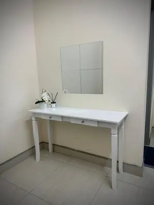 a white dressing table with a mirror on the wall at Homestay Adyana in Raub
