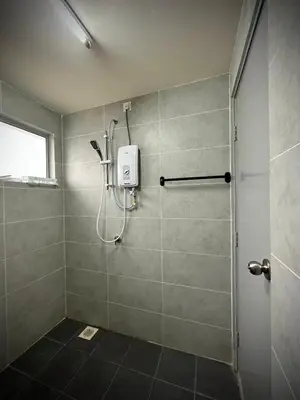 a shower stall in a bathroom with a window at Homestay Adyana in Raub