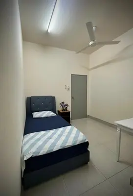 a bedroom with a bed and a ceiling fan at Homestay Adyana in Raub
