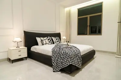 a bedroom with a black and white bed and a window at Georgetown Chanel-Style Jacuzzi & KTV 5BR 18pax F in George Town