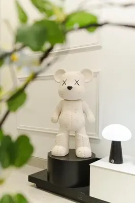 a toy teddy bear sitting on a black stand at Georgetown Chanel-Style Jacuzzi & KTV 5BR 18pax F in George Town