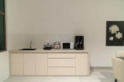a white kitchen with a counter top with a microwave at Georgetown Chanel-Style Jacuzzi & KTV 5BR 18pax F in George Town