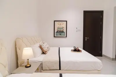 a bedroom with a bed and a table with a lamp at Georgetown Italian-Style Jacuzzi KTV 5BR 18pax G in George Town