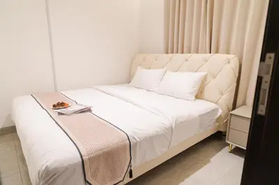 a bedroom with a bed with a plate of food on it at Georgetown Italian-Style Jacuzzi KTV 5BR 18pax G in George Town