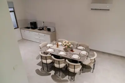 a dining room with a table with chairs and a kitchen at Georgetown Italian-Style Jacuzzi KTV 5BR 18pax G in George Town