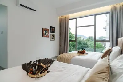 a bedroom with two beds and a large window at Georgetown Modern Brown-Colored KTV 5BR 18pax H in George Town