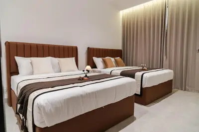 two beds in a hotel room withskirts at Georgetown Modern Brown-Colored KTV 5BR 18pax H in George Town