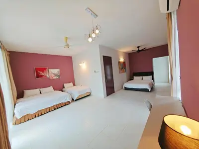 a large room with two beds and red walls at 2 Spacious Lupsxury conor villa garden Parking group family gathering wedding in Gelugor