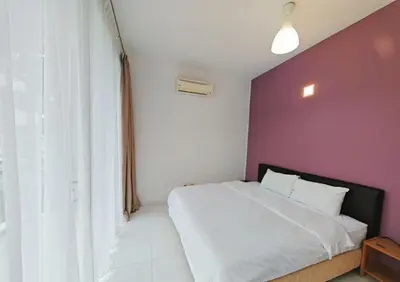 a bedroom with a white bed and a purple wall at 2 Spacious Lupsxury conor villa garden Parking group family gathering wedding in Gelugor