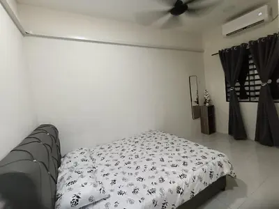 a bedroom with a bed and a ceiling fan at Aleesa Homestay in Tapah
