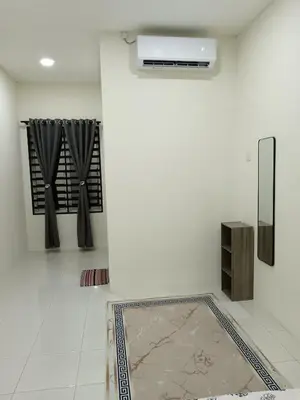 a room with a white wall with a radiator and a rug at Aleesa Homestay in Tapah