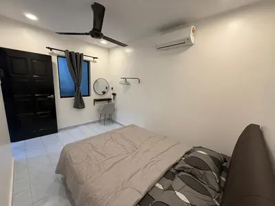 a bedroom with a bed and a ceiling fan at raub homesty in Raub