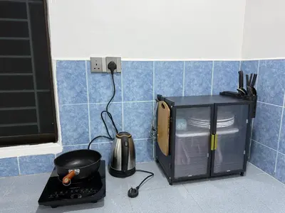 a kitchen with a microwave and a tea kettle on a counter at raub homesty in Raub