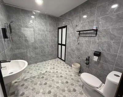 a bathroom with a toilet and a sink at raub homesty in Raub