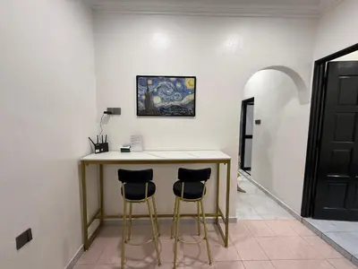 a room with a table and two stools at raub homesty in Raub
