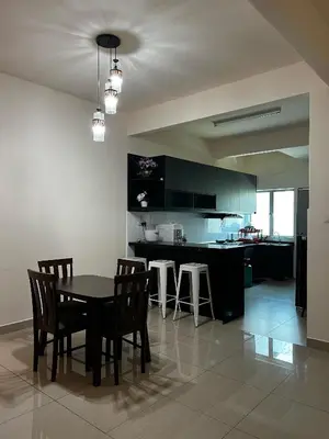 a kitchen and dining room with a table and chairs at Homestay Adyana in Raub
