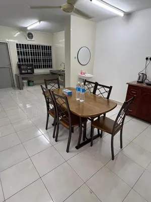 a dining room with a wooden table and chairs at Raub homesty in Raub