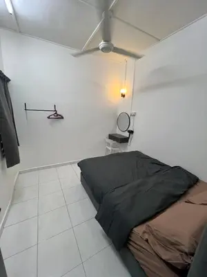 a bedroom with a bed in a white room at Raub homesty in Raub