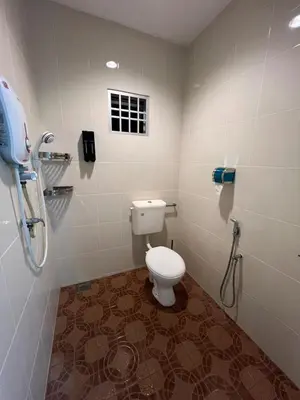a bathroom with a toilet and a phone on the wall at Raub homesty in Raub