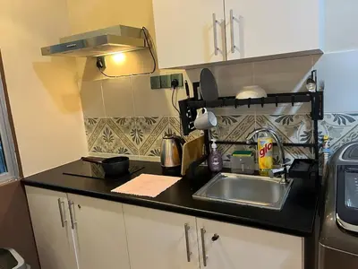 a kitchen with a sink and a counter top at The Anderson Ipoh AA4 7pax, Smart TV & Wi-Fi in Ipoh