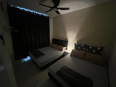 a small room with a bed and a ceiling fan at The Anderson Ipoh AA4 7pax, Smart TV & Wi-Fi in Ipoh