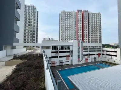 an apartment building with a swimming pool and tall buildings at The Anderson Ipoh AA4 7pax, Smart TV & Wi-Fi in Ipoh