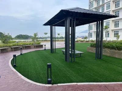 a pavilion with a picnic table in a field of grass at The Anderson Ipoh AA4 7pax, Smart TV & Wi-Fi in Ipoh