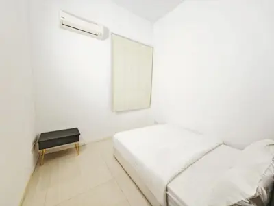 a white bedroom with a bed and a table at 142 spacious 3storey 6BR 6bath for big family wedding birthday easy parking in Gelugor