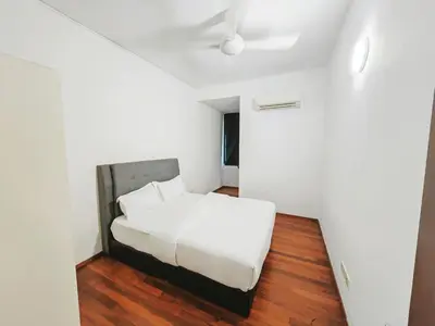 a small bedroom with a white bed and wooden floors at 142 spacious 3storey 6BR 6bath for big family wedding birthday easy parking in Gelugor