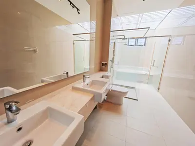 a bathroom with a sink and a toilet and a mirror at 142 spacious 3storey 6BR 6bath for big family wedding birthday easy parking in Gelugor