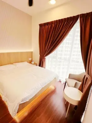 a bedroom with a bed and a chair and a window at Taste of Home in Ipoh
