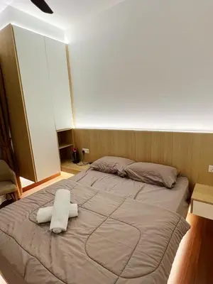 a large bed with two towels on top of it at Taste of Home in Ipoh