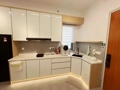 a kitchen with white cabinets and a sink at Taste of Home in Ipoh